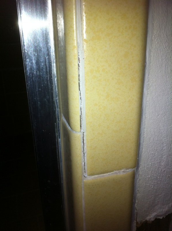 cracking of grout throughout shower from house settling