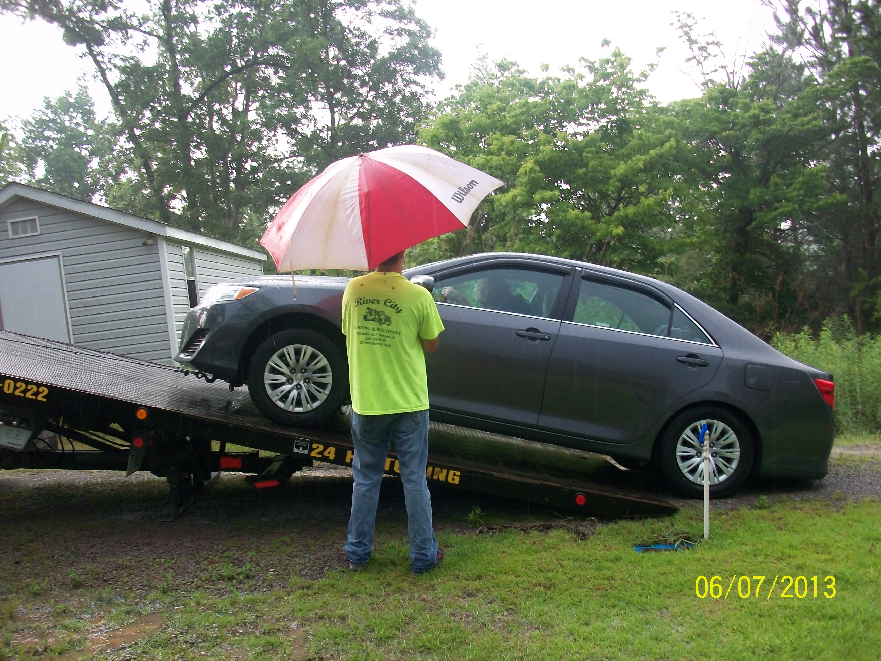 2013 Toyota Camry L being loaded by Toyota Wrecker Service for Serra Toyota