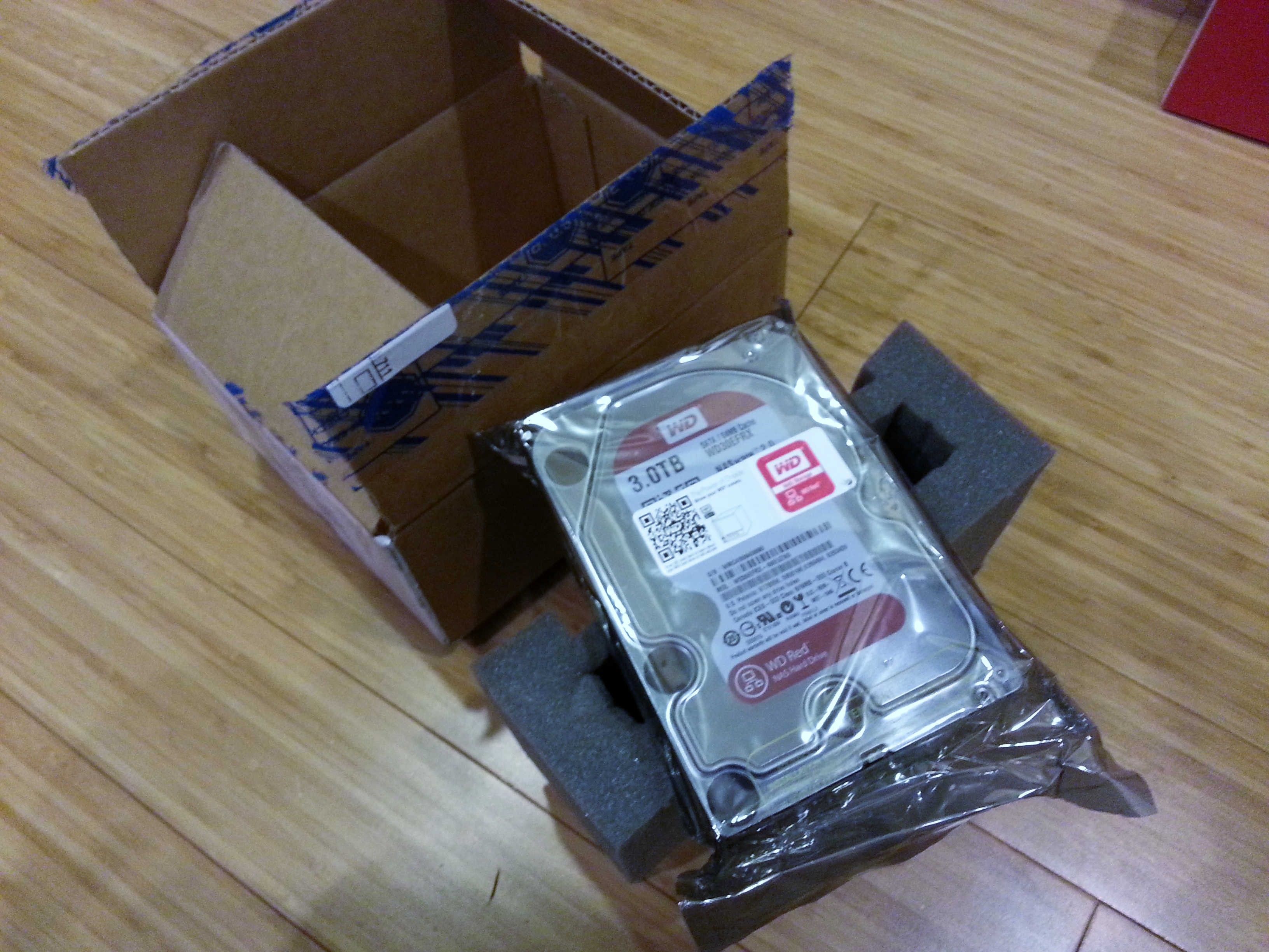Picture of the drive, foam sleeve, and shipping box as shipped from TigerDirect.