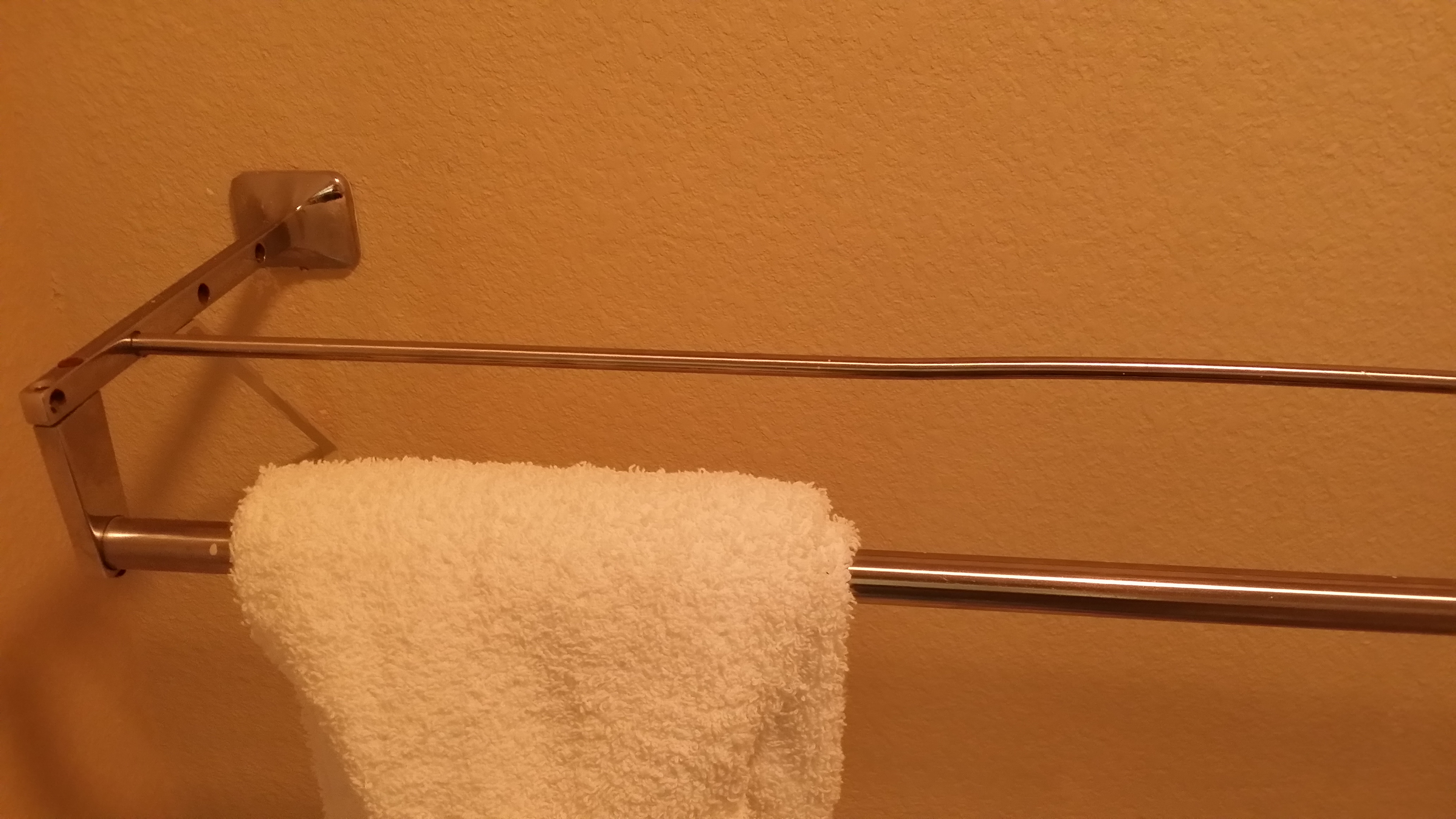 Rusty bent towel rack in the bathroom