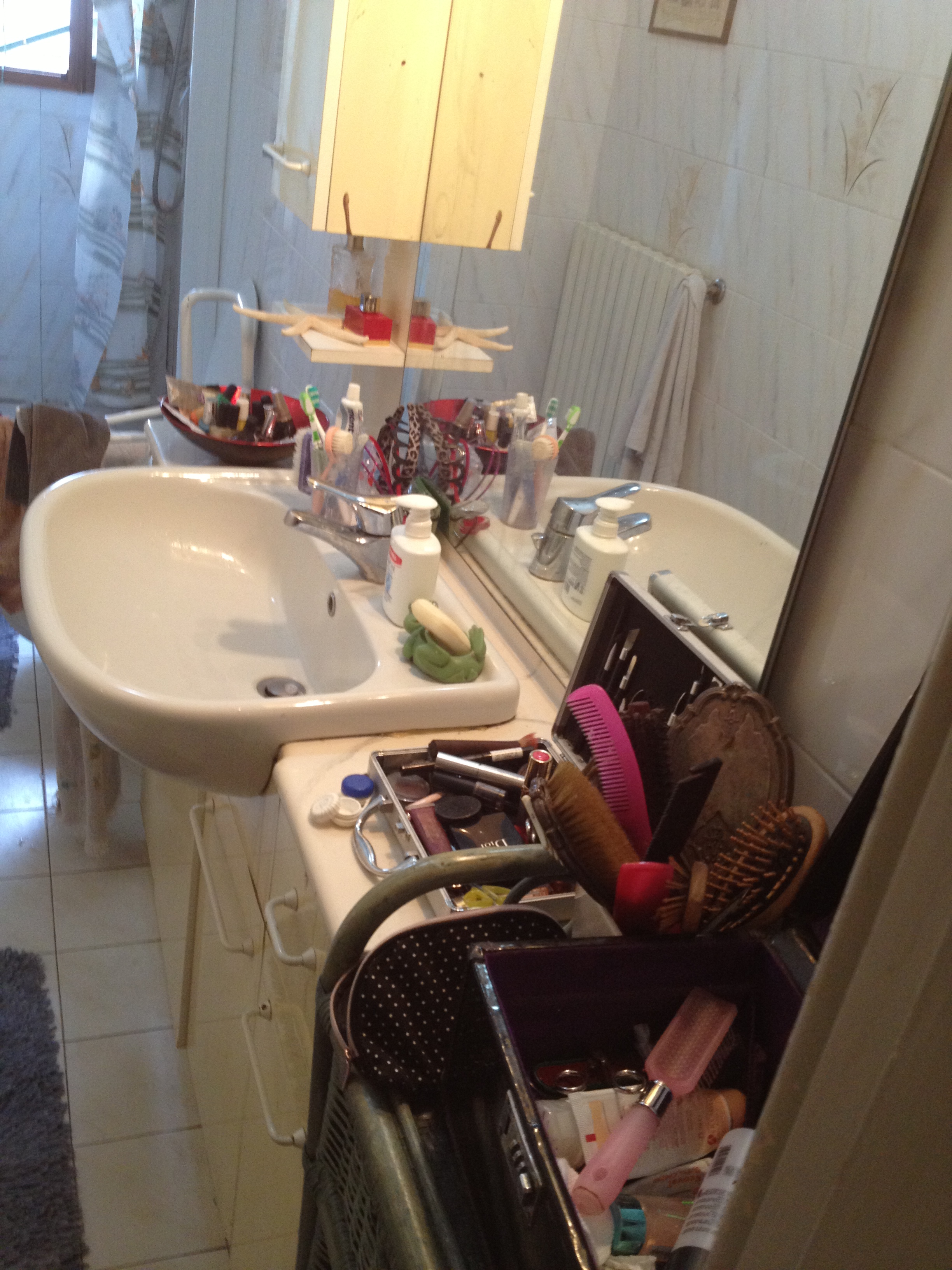 Bathroom and counter tops.  Littered with hosts make-up supplies.