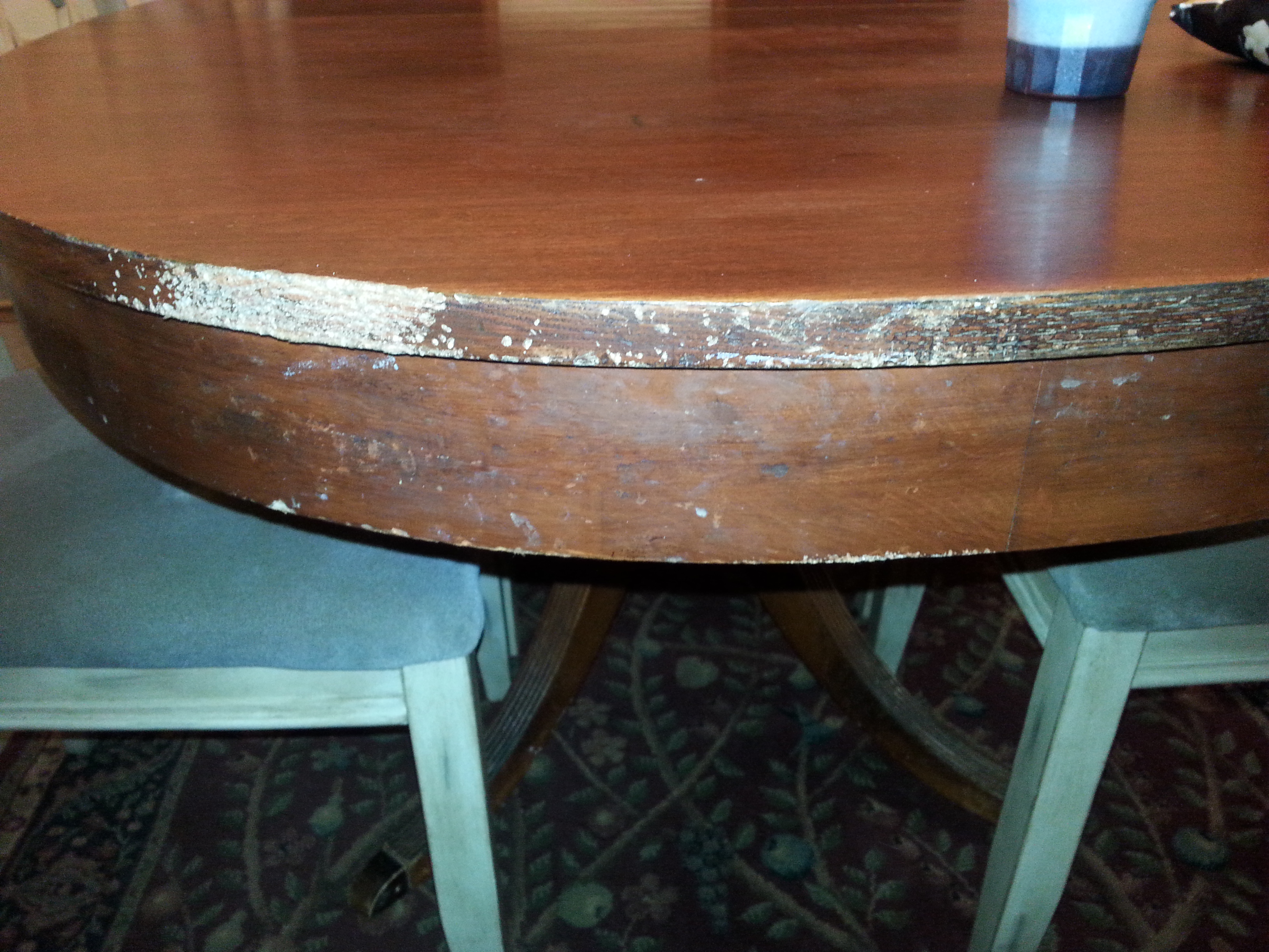 Our antique dining table, that my husband spent a week refinishing. Looks like it was dragged across concrete.