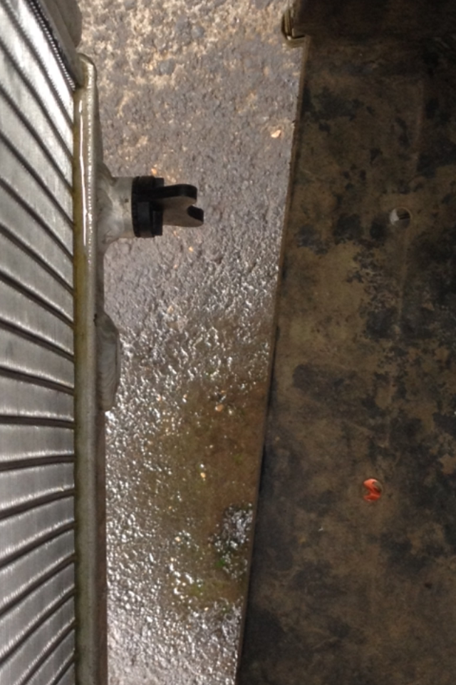 The leak is at the bottom of the radiator core, on the lip. The vehicle is turned off in the picture, but you clearly can see the puddle on the ground all from only 5 minutes of running the vehicle. 