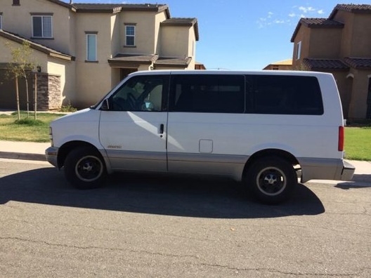 The Chevy Astro van he drives while putting up flyers in new home subdivisions. He also drives a green Ford a Crown Victoria