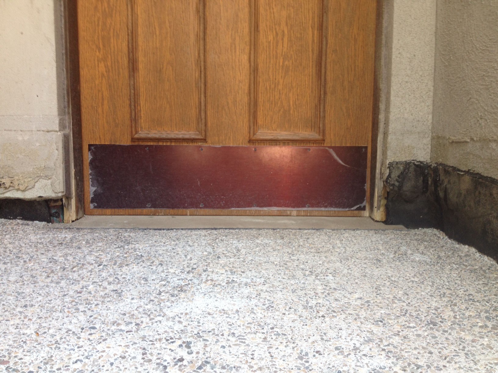 Concrete poured up to the top of the front door threshold