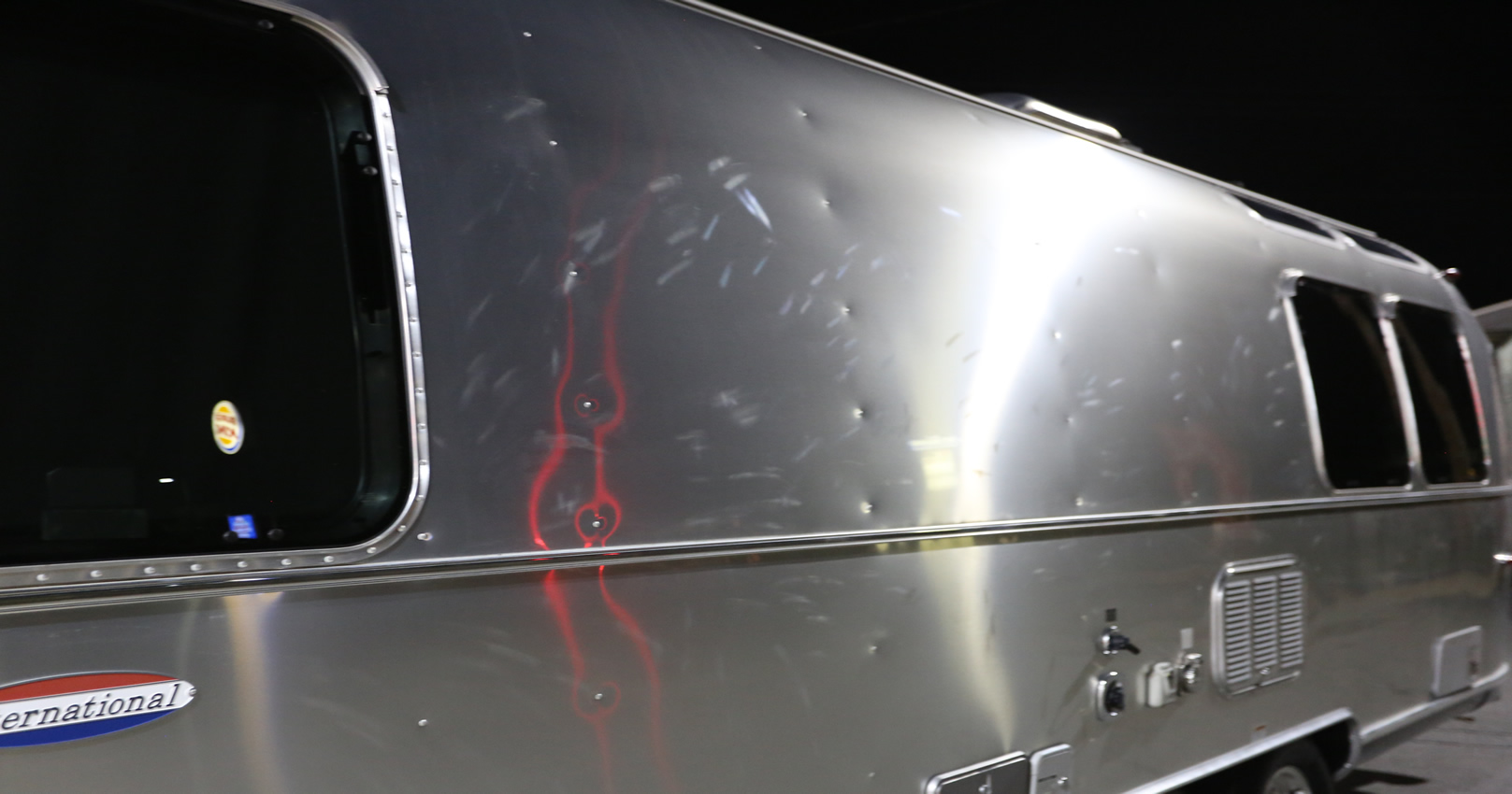 Dents are under all the sanding marks throughout the side panels. Not to be mistaken for rivets or red reflection.