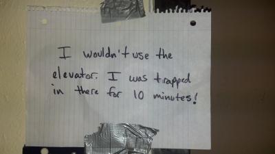 An angry note complains about the dangerous and often broken elevator.