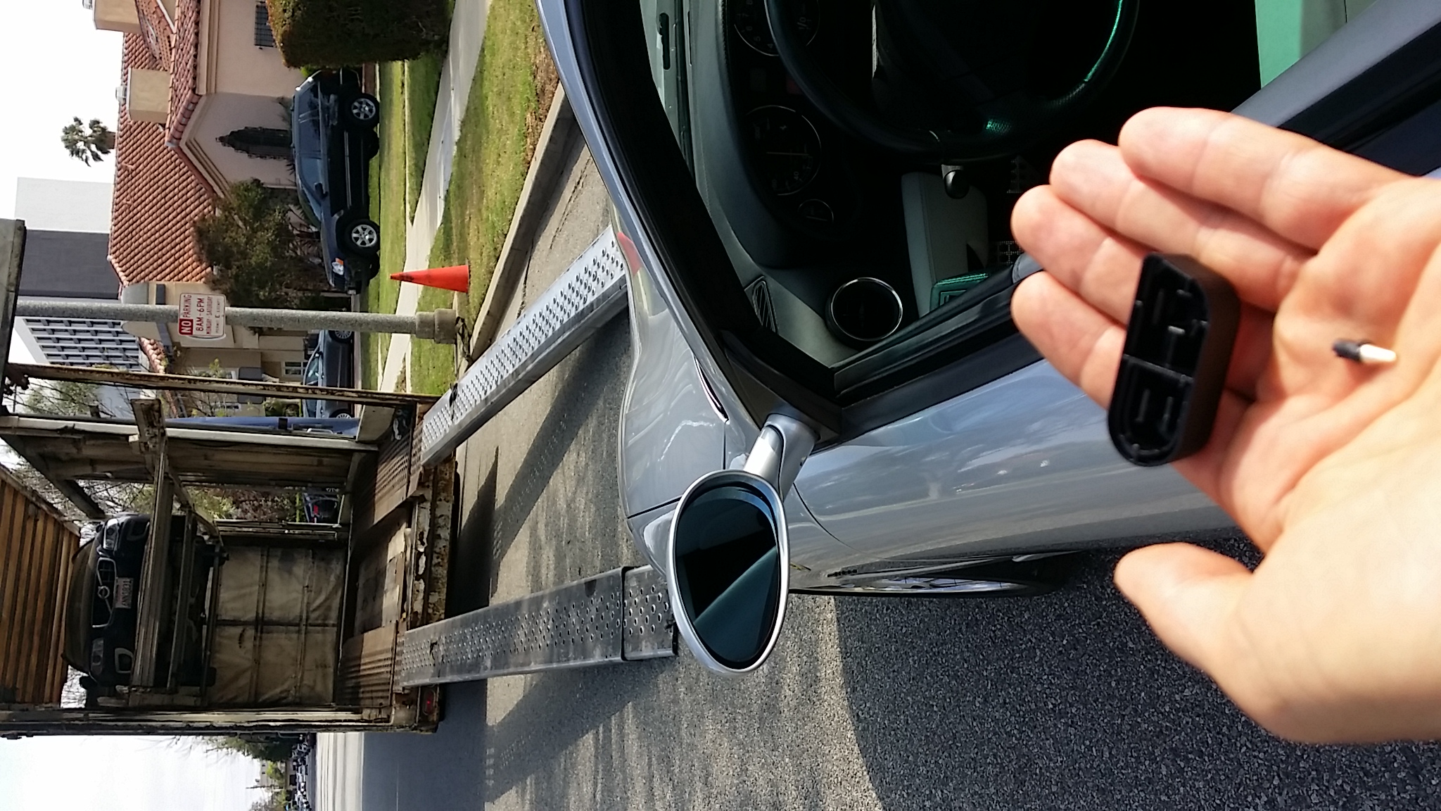 The broken window switch with the Ferrari still exactly where they unloaded it behind their truck.