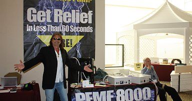 Charlie Farricielli promoting his knock-off PEMF 8000 with stolen trade show banners.