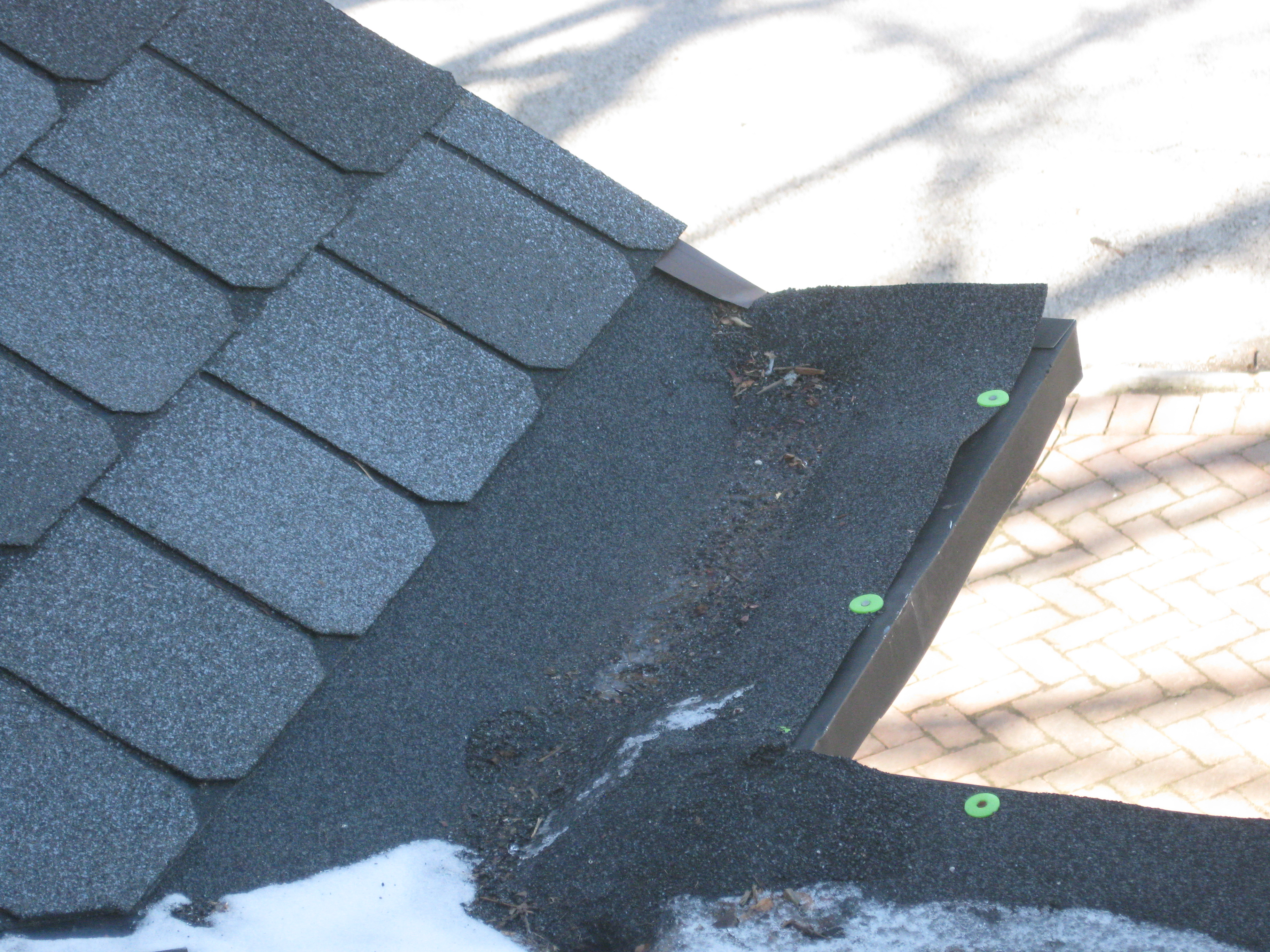 The old gutter should have been torn off instead of carelessly covering them over. The section of porch underneath substained damage from water leaking thru the old gutter that was never torn off and 