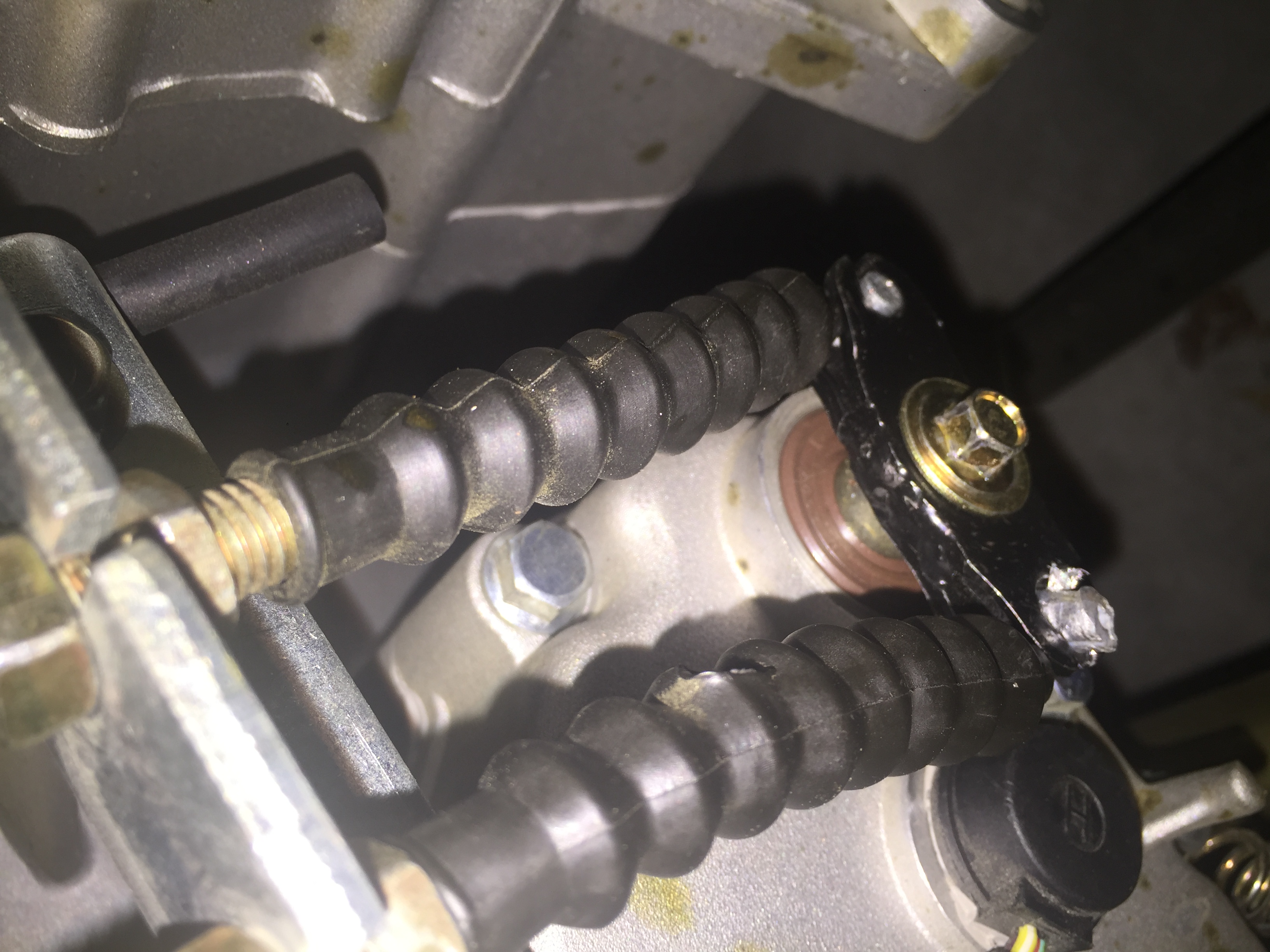 Where one bolt for the transmission was not installed tight enough and had to be replaced including the forward throttle cable