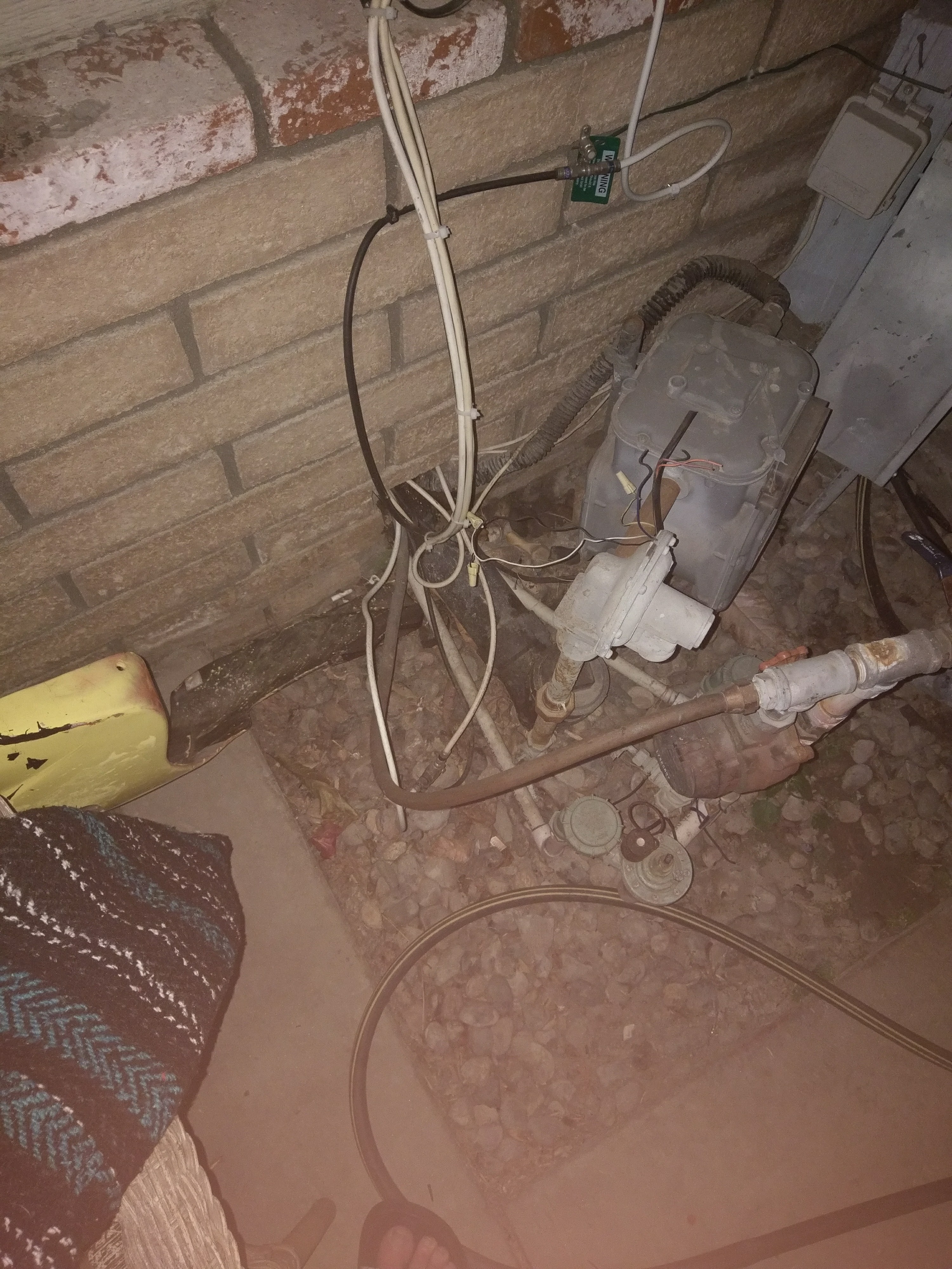 Wires wrapped around gas meter that's not braced and scraping against brick. 