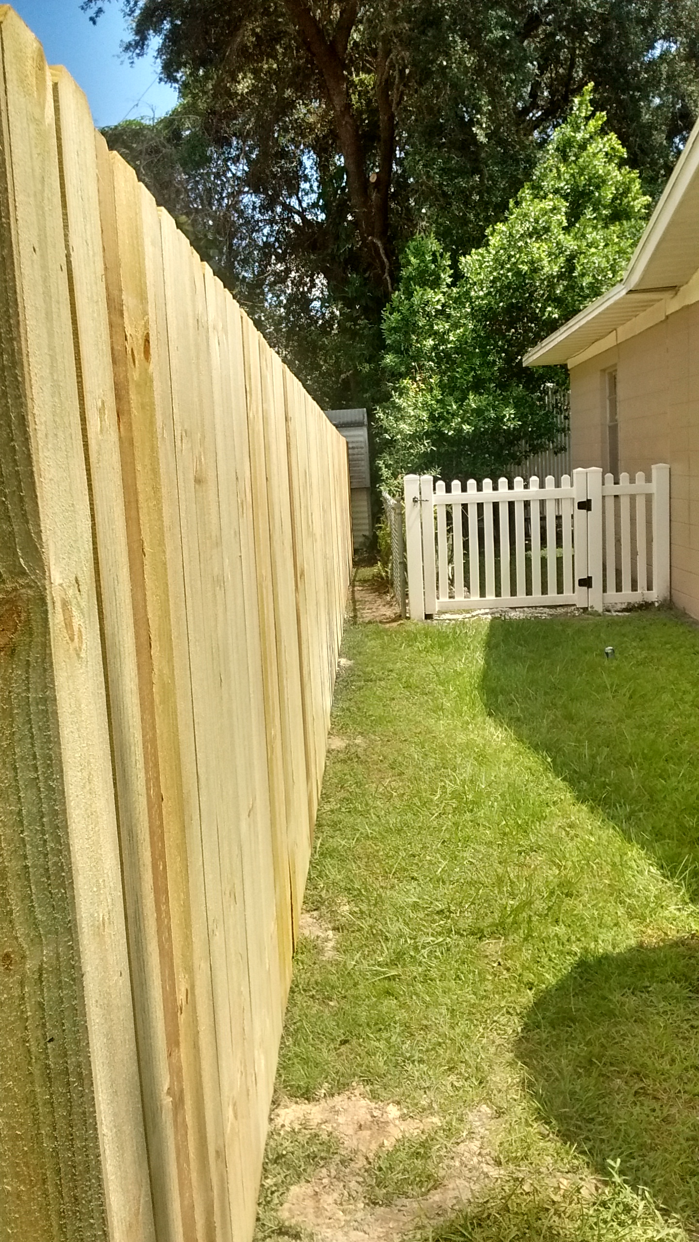 This is the alley the crew created on the right side of my house. The white vinyl gate belongs to my neighbor.