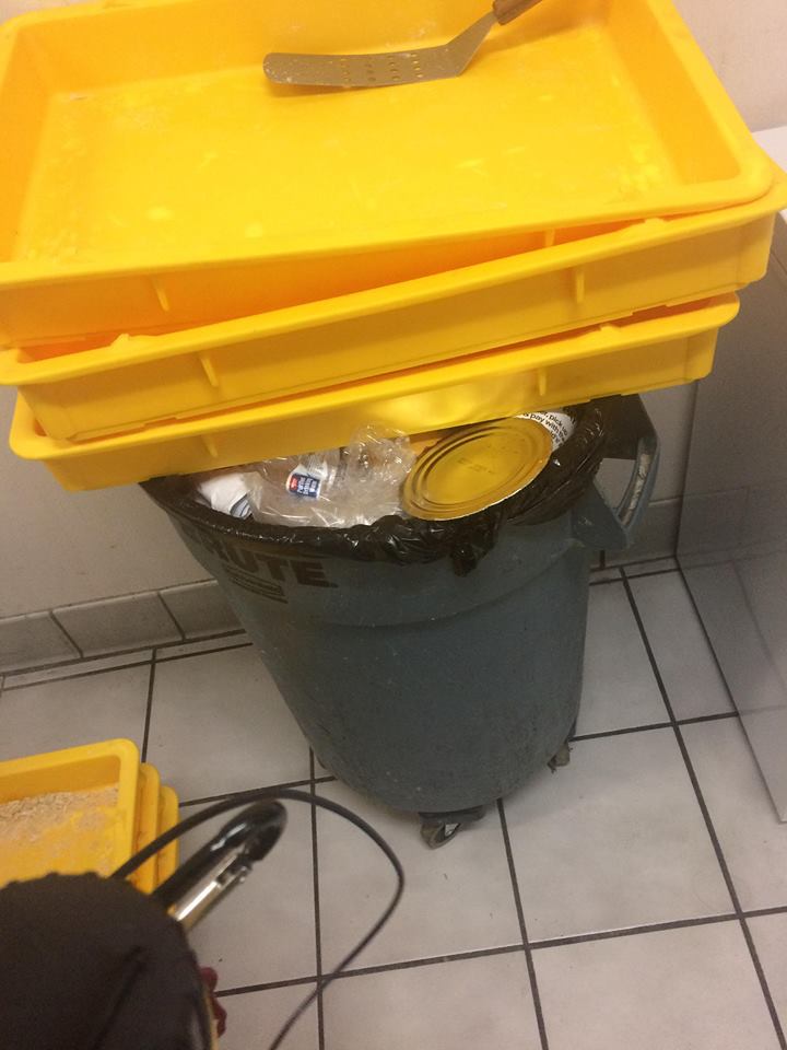 Food for customers on full garbage can 