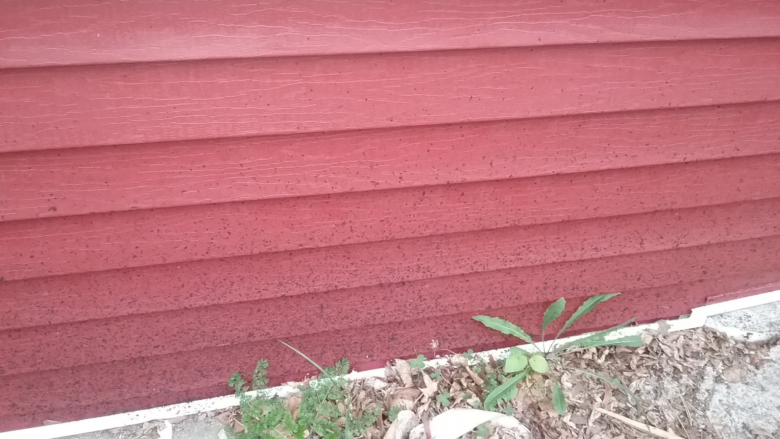 Splattered roofing material from roof