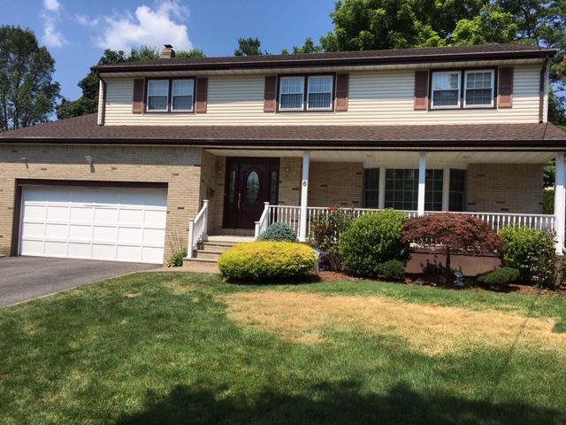 faded lawn and crooked shingles on the front roof