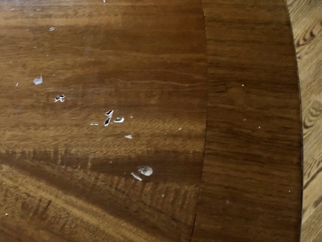 Damaged antique table before moving it from room