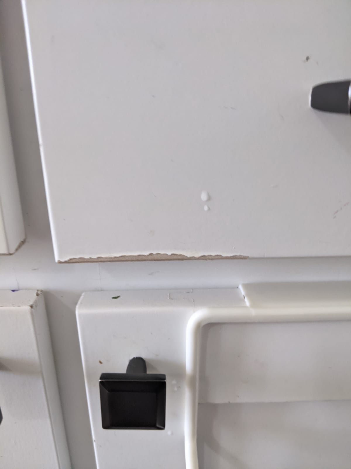 paint peeling off on corners on all cabinet doors.