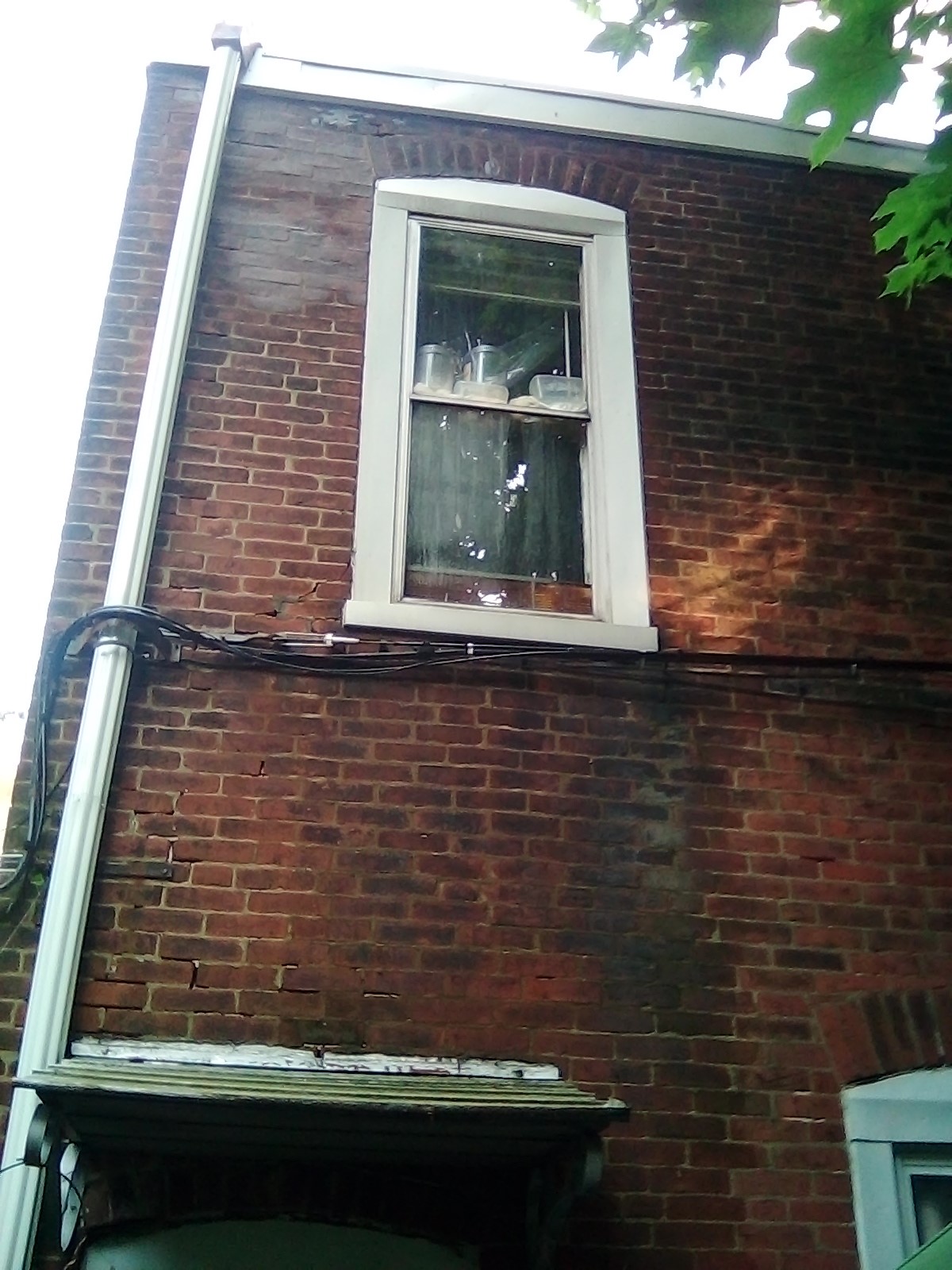 Water pours off roof into this window