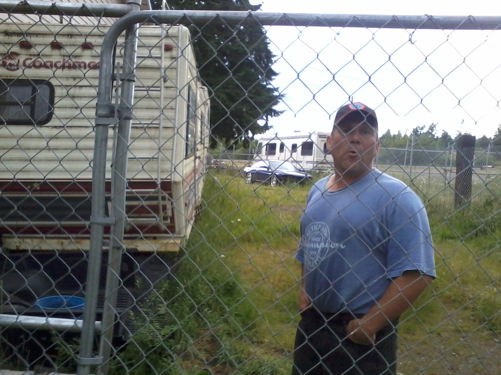 Inside my fenced compound sticking his tongue out