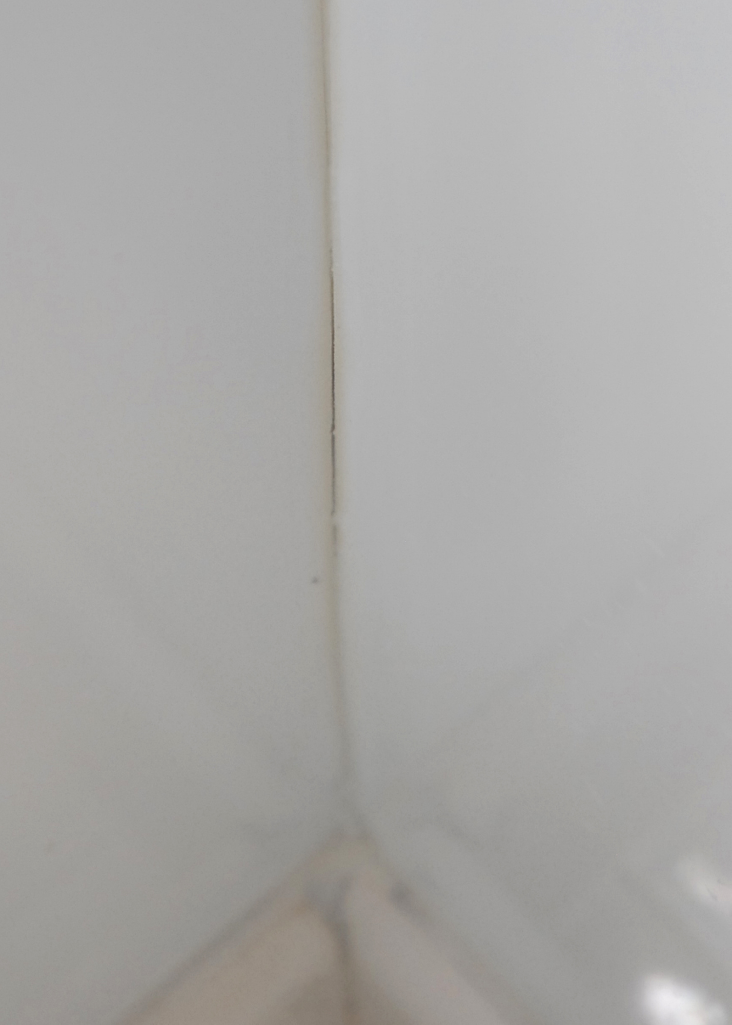 This is a crack or fissure near the shower floor showing what happens when the wrong caulking material is used.  ReBath was notified over 3 and 1/2 months ago, immediately after the job was completed,