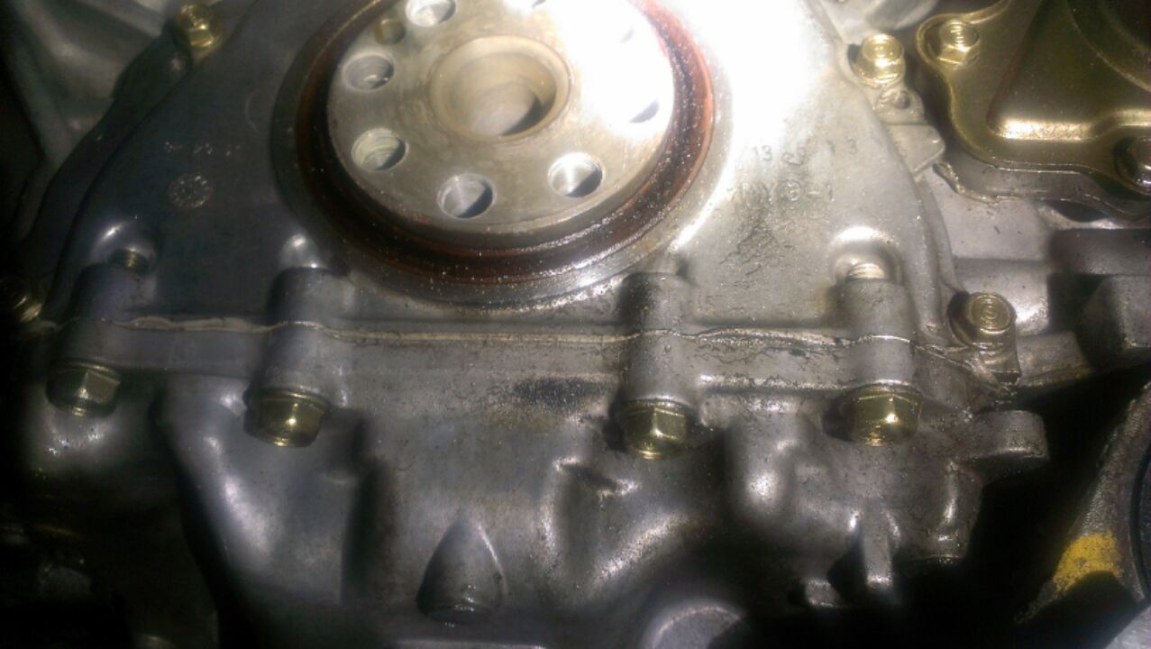 Leaking from the Rear  Main seal ,  the backing plate was not resealed and the pinion seal plate to the left is wet as  well.   The previous shop used loc-tite on the screws that attach the flywheel. 