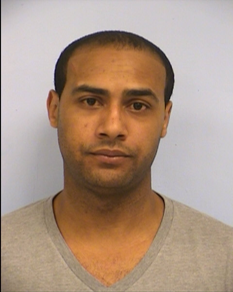 Christopher Oyolokor's February 2014 Travis County mugshot for Domestic Violence.  