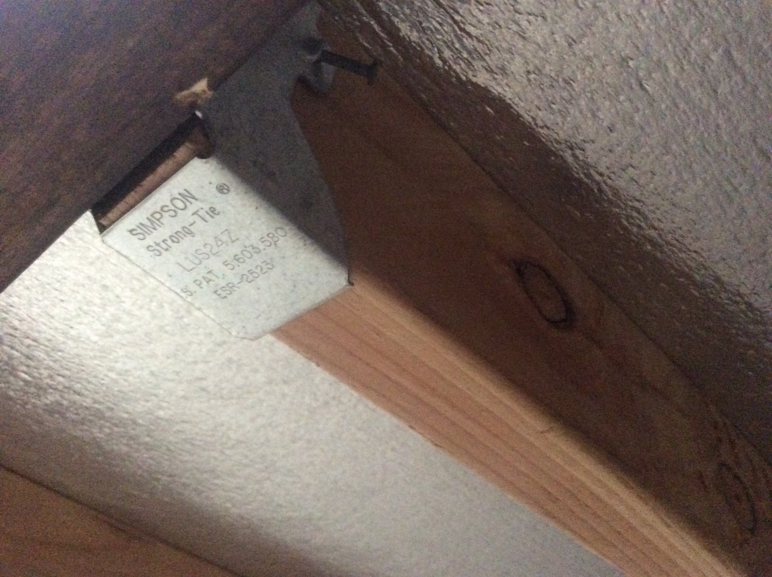 Joist bracket added, along with vertically placed 2x4, replacing the poorly constructed rail previously on the bed