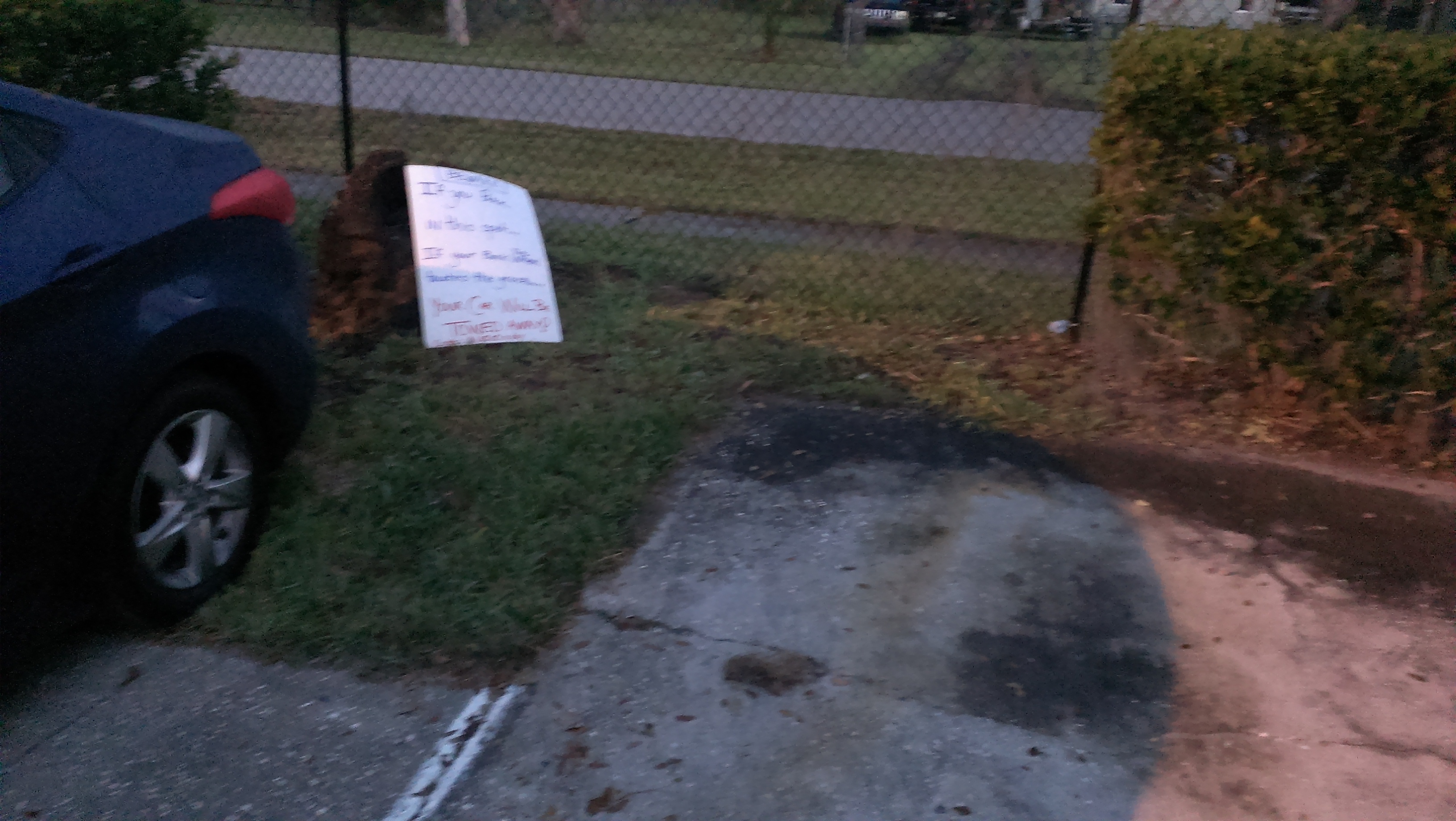 Better picture end of parking spots with tree stump in back.  NO curb blocker on either parking spots.