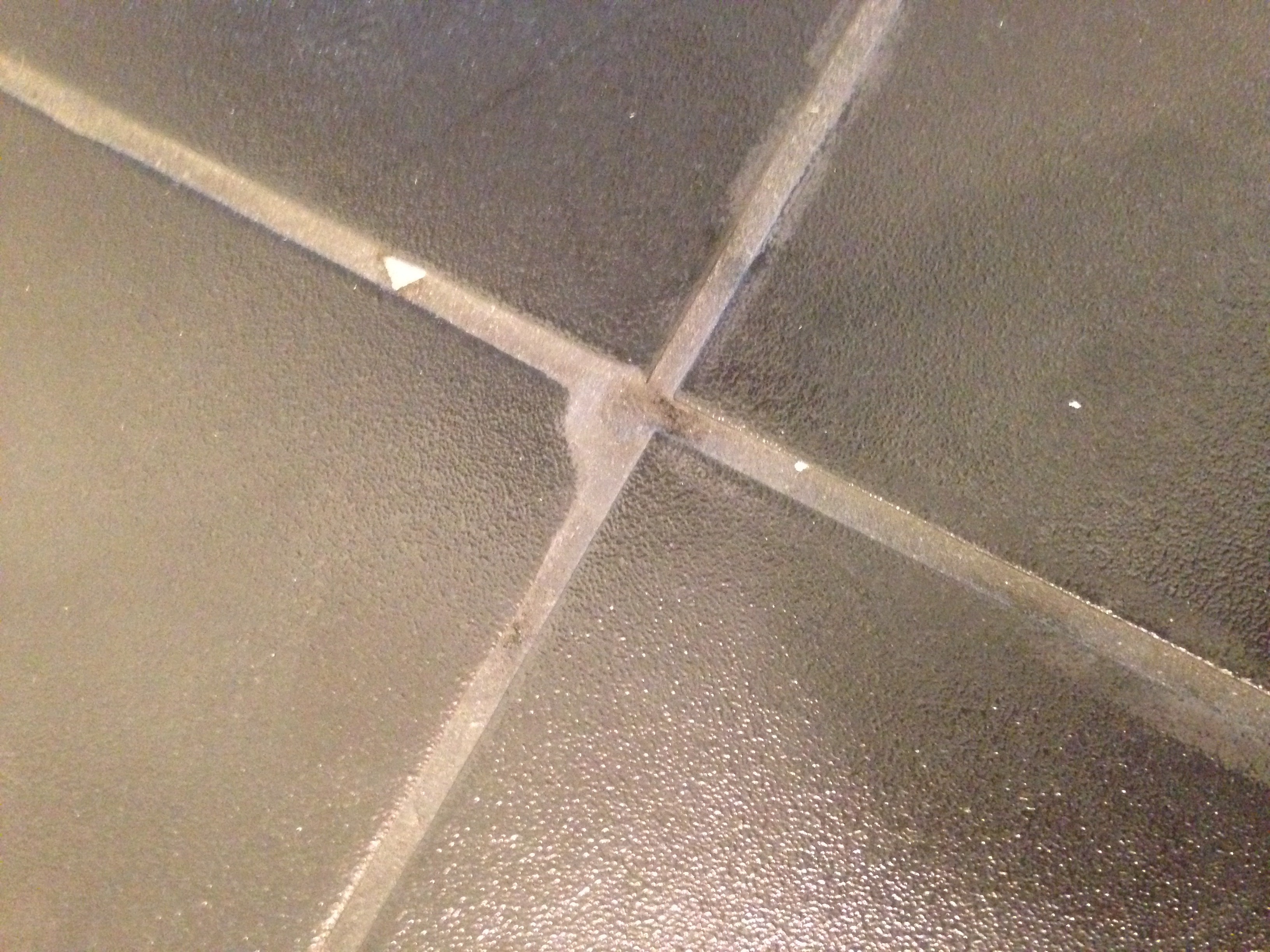 Grout with debris in it, holes and on tile