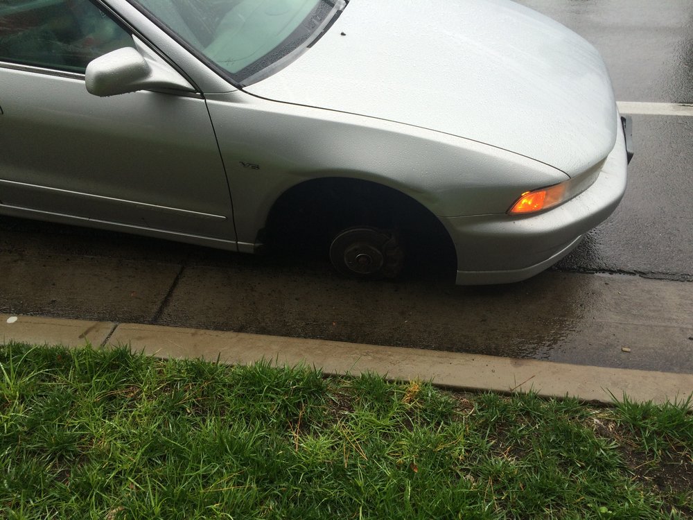 My car on the ground after it skid across an intersection.