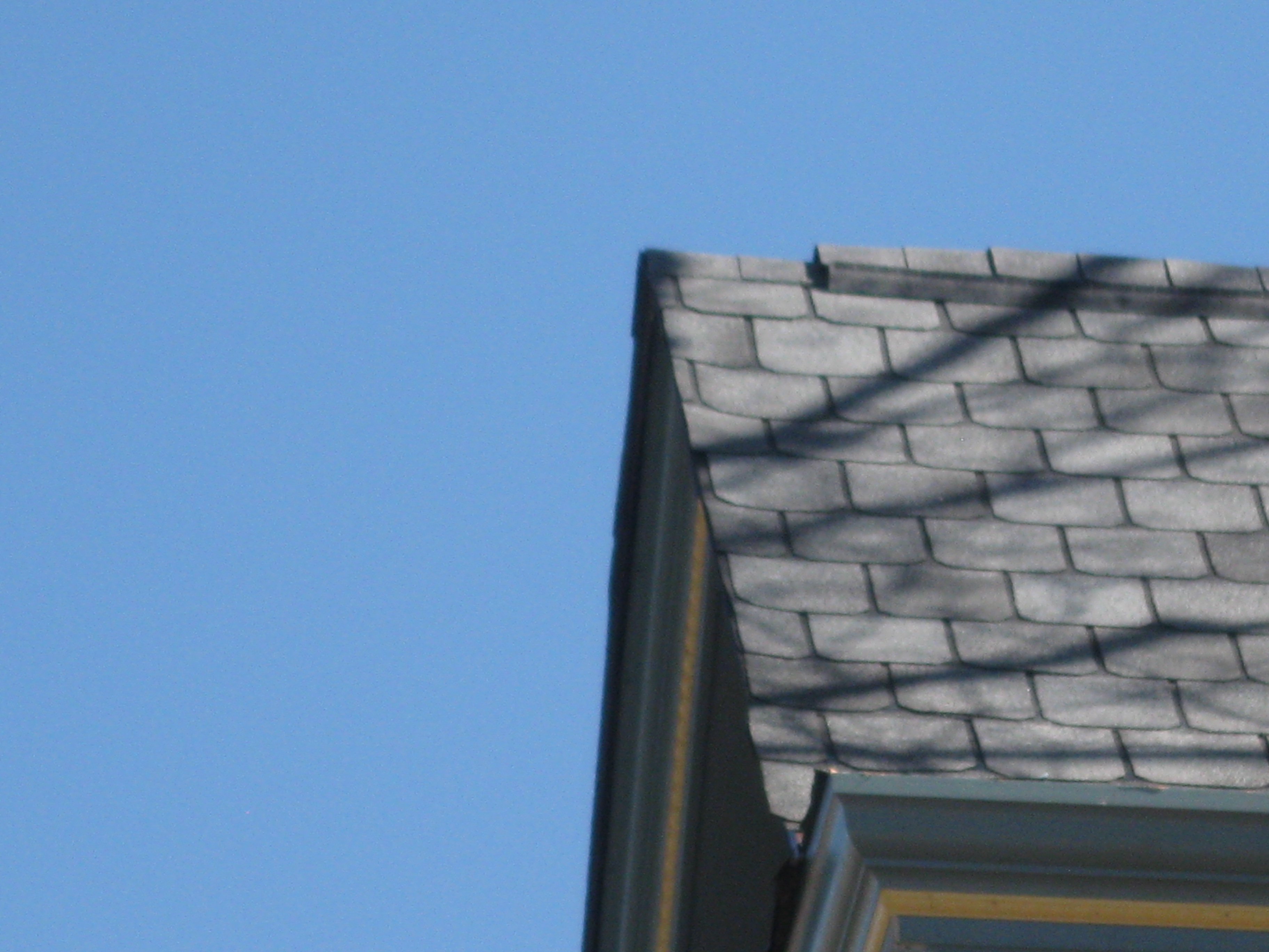 Look at the left edge. See the inconsistent shingle tabs sizes and slivers of shingles. See the shingles that curl upward. Is this quality roofing?
