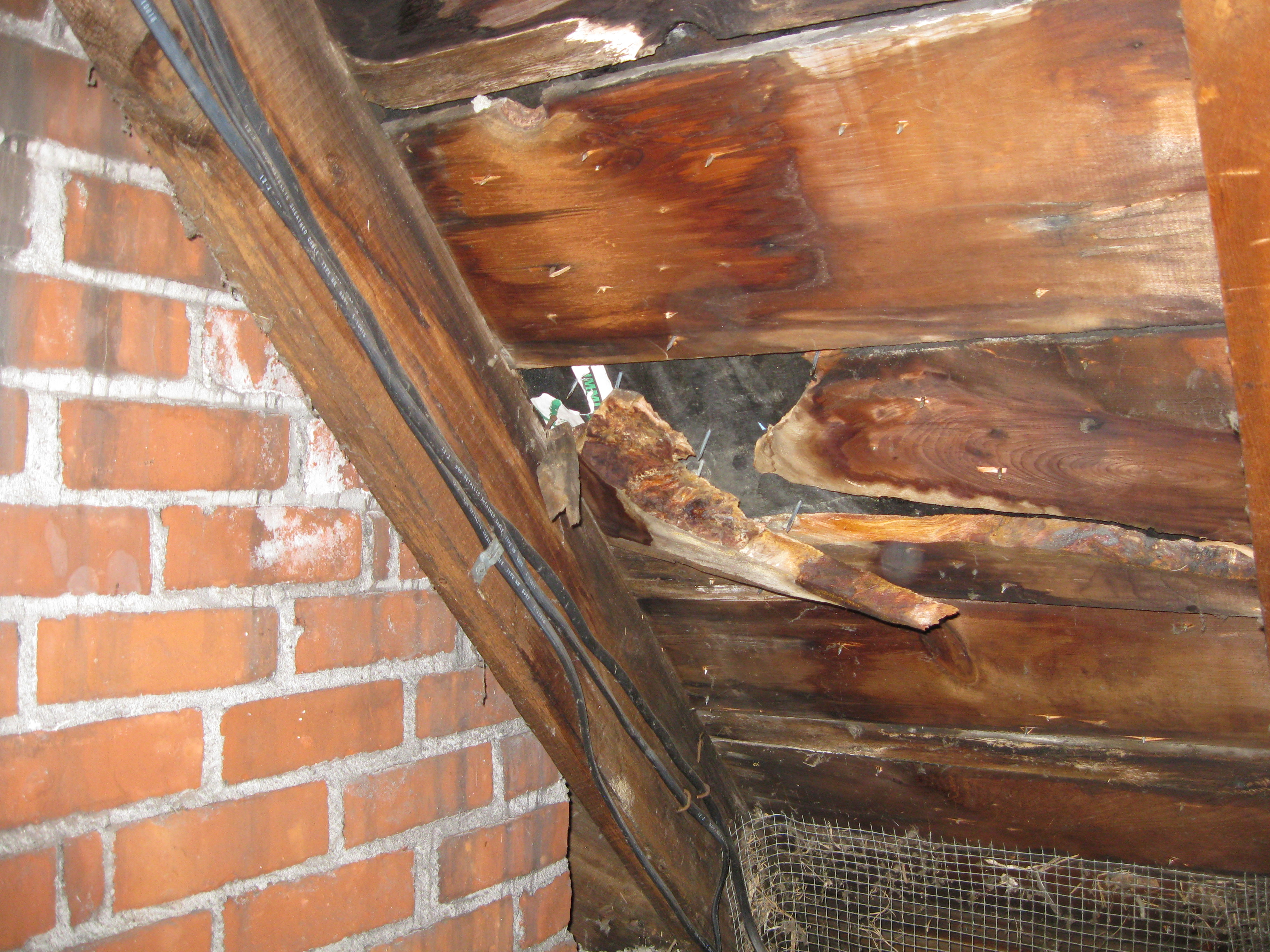 Shows an area of the roof from inside the attic that should have had new sheeting. Our witness for the fraudulent ridge vents saw this too. Is this quality roofing?
