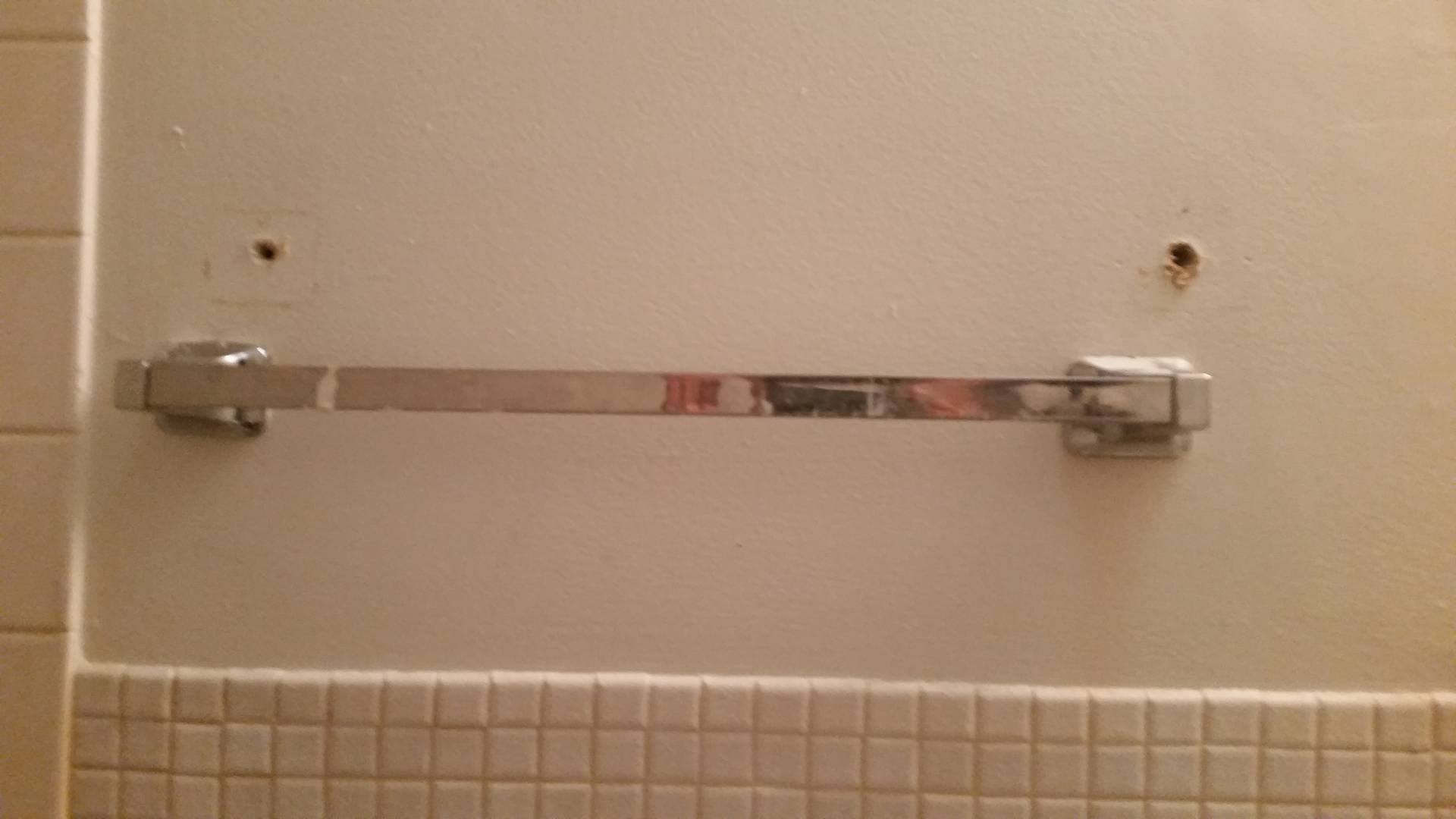 old holes that were never patched after maintenance "fixed" towel rack that fell during the first few weeks after I moved in
