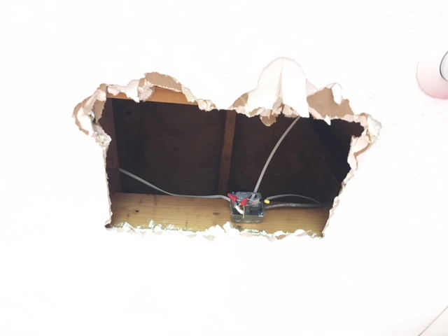 Busted sheetrock and exposed wires