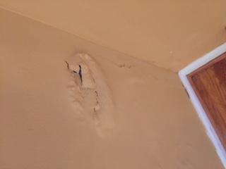 "Bubbled" hole in our drywall. Never fixed.