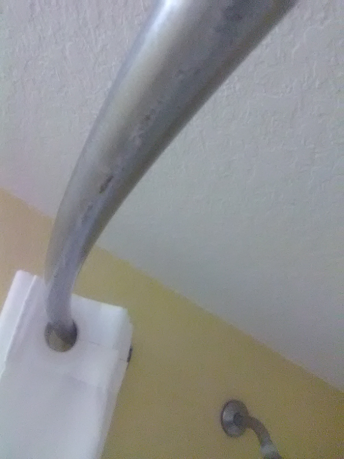 Shower rod flaking off chrome and rust.