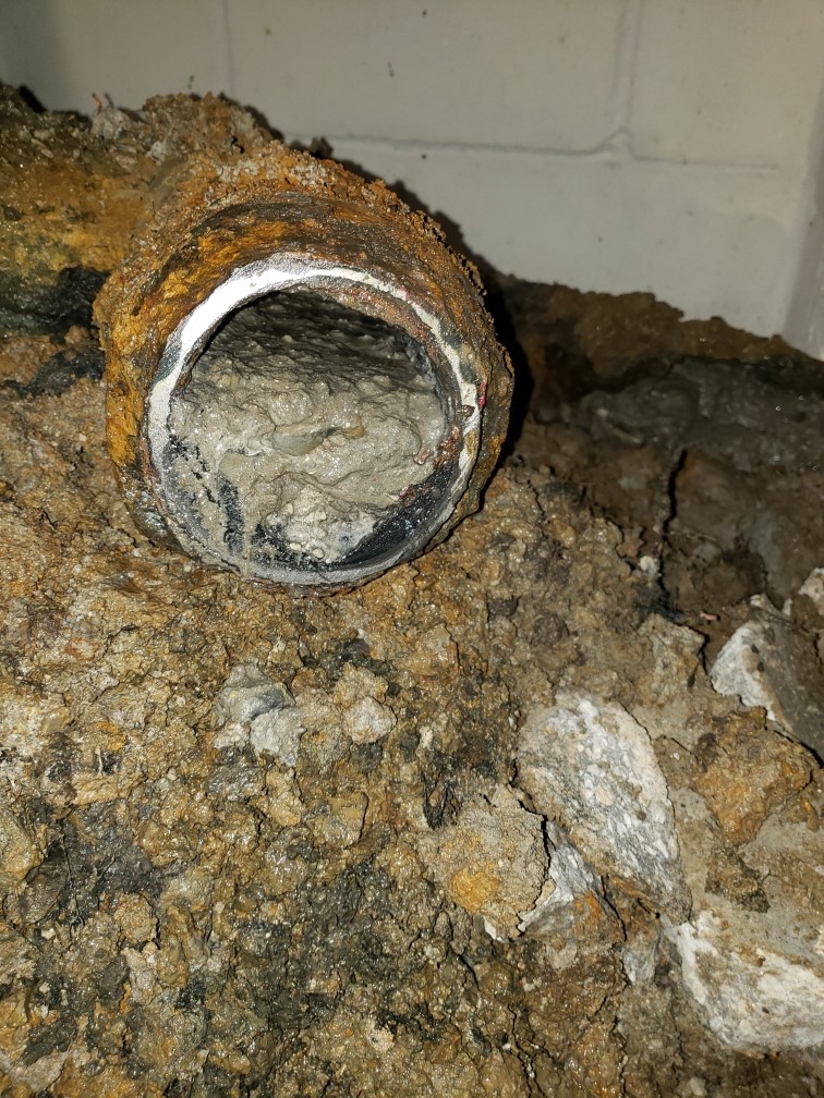 Sewage line that had concrete & rocks flushed down