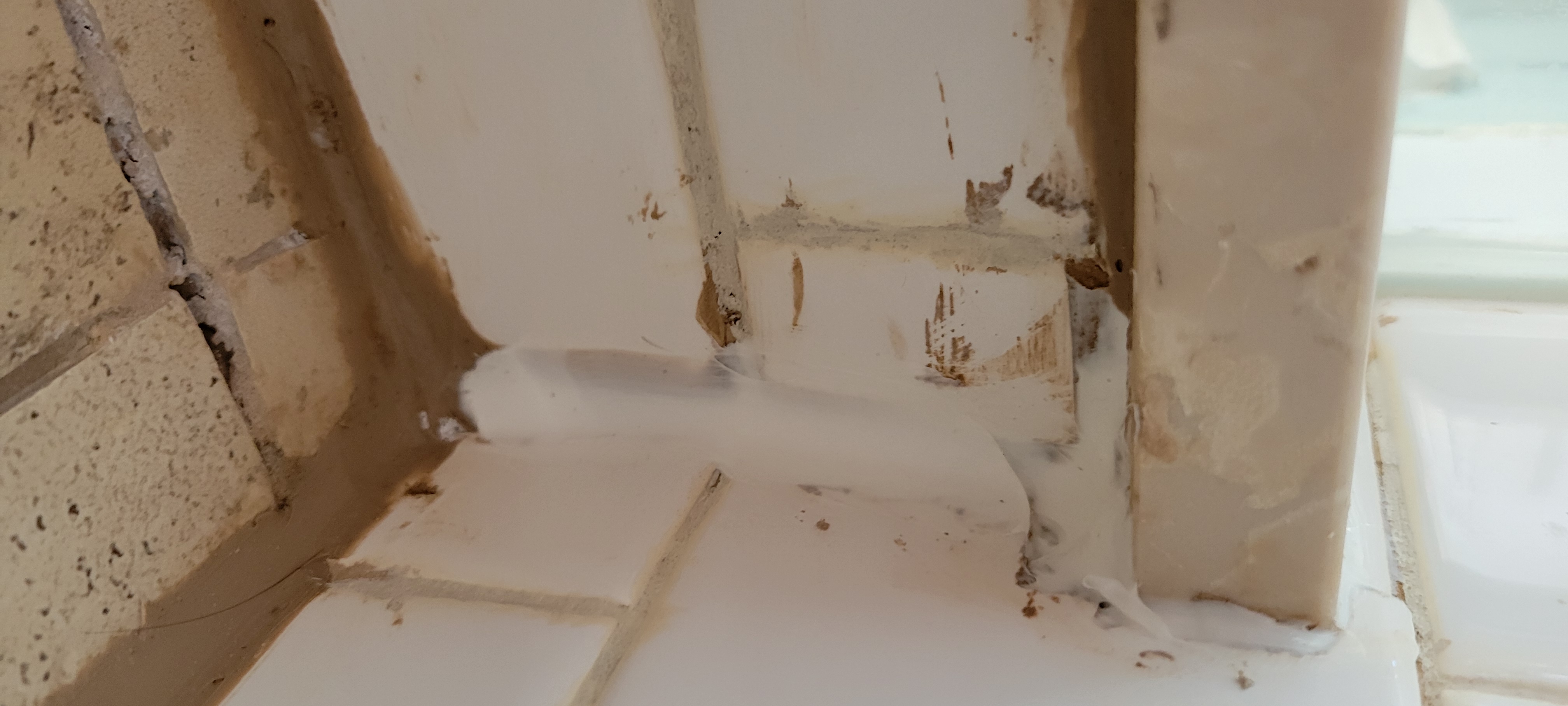 Caulk used to fill gaps from mis-cut tiles