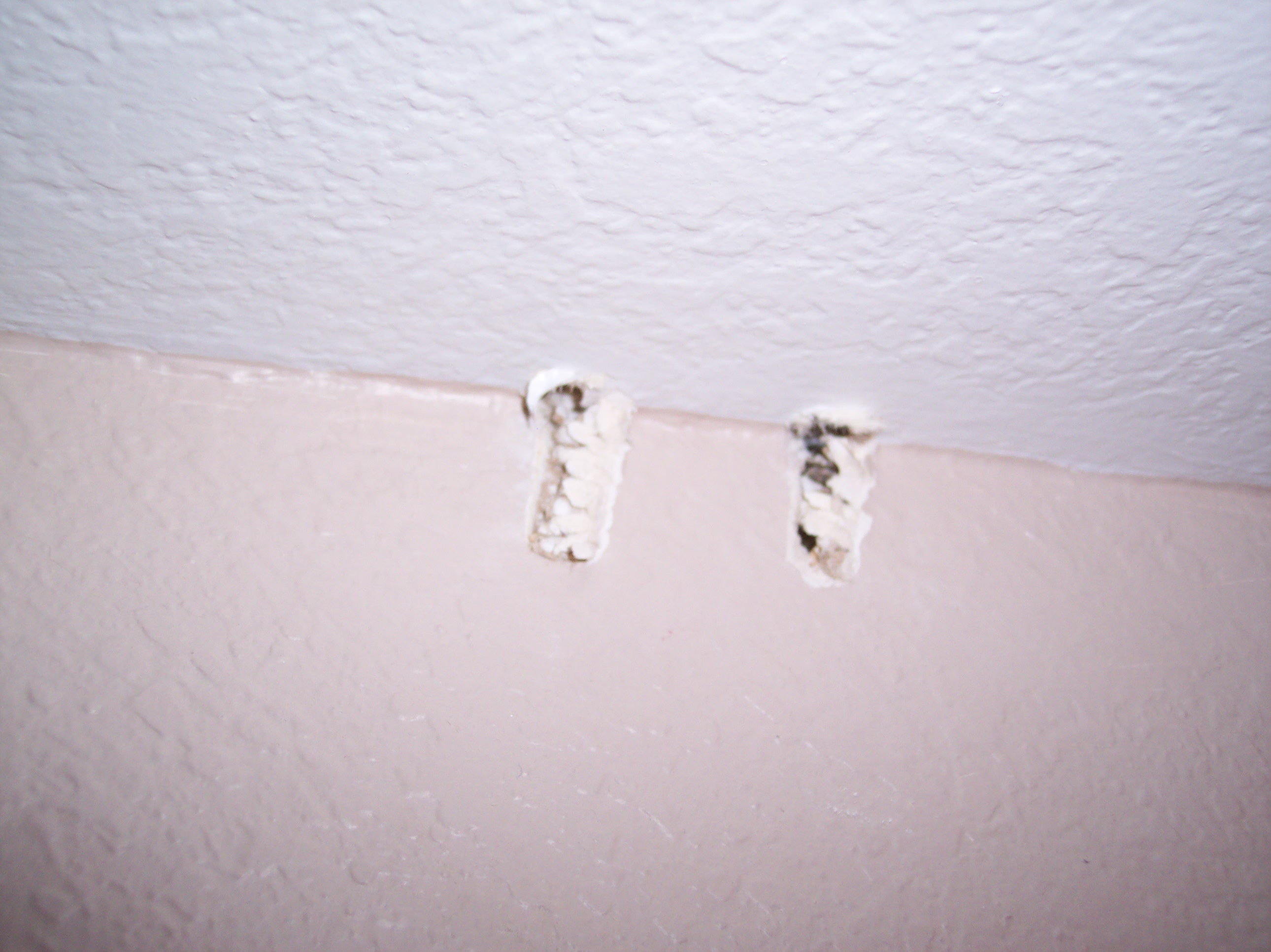 Damaged wall and ceiling from Tim Lime drilling.